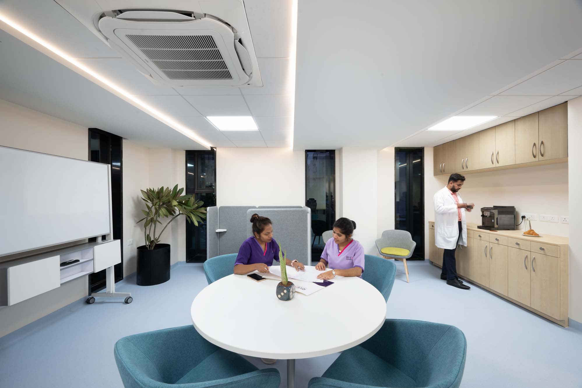 Team collaboration moment in a contemporary clinical workspace