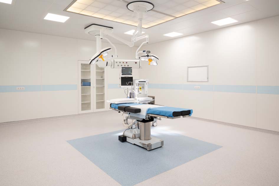 High-tech vascular intervention suite with adjustable operating table and overhead illumination